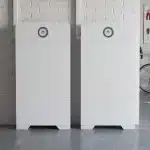 Huawei Power-M 10kW / 30kWh: two 15kWh towers side by side against a white brick garage wall