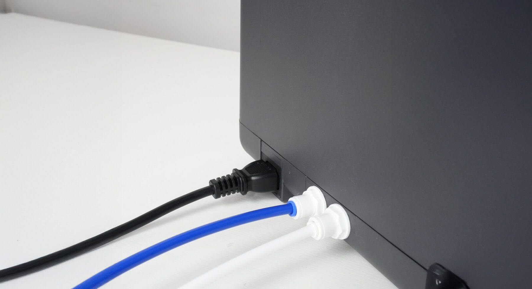 Inlet and drain pipes connected to the back of the DNA Water Bar
