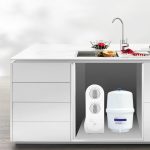 DNA Pure Flow installed in a kitchen cupboard under the sink with its own faucet above
