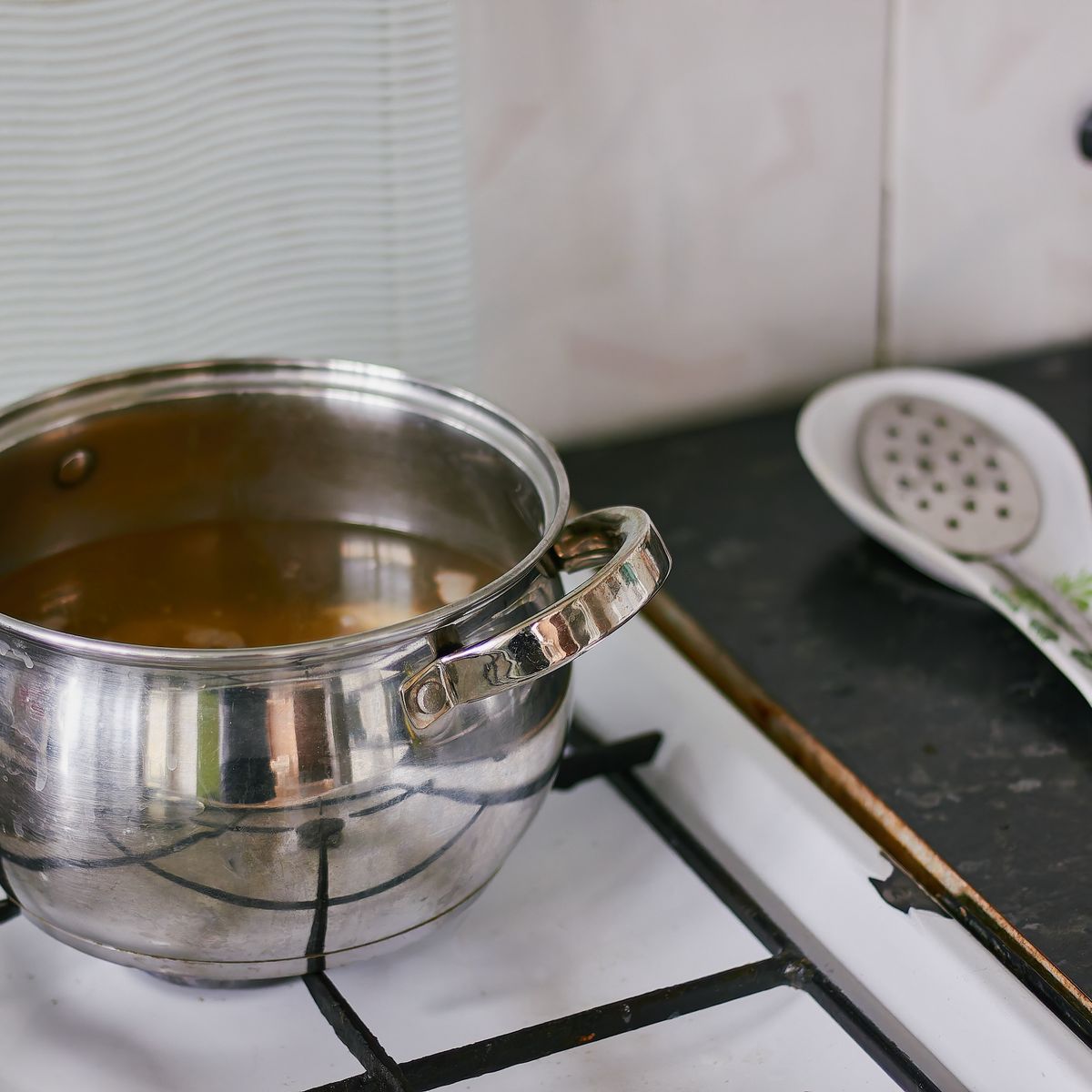 A stainless steel pot on a kitchen hob