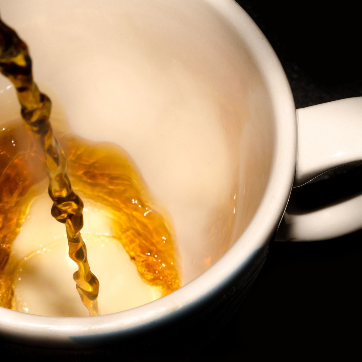 Hot tea poured into a white cup