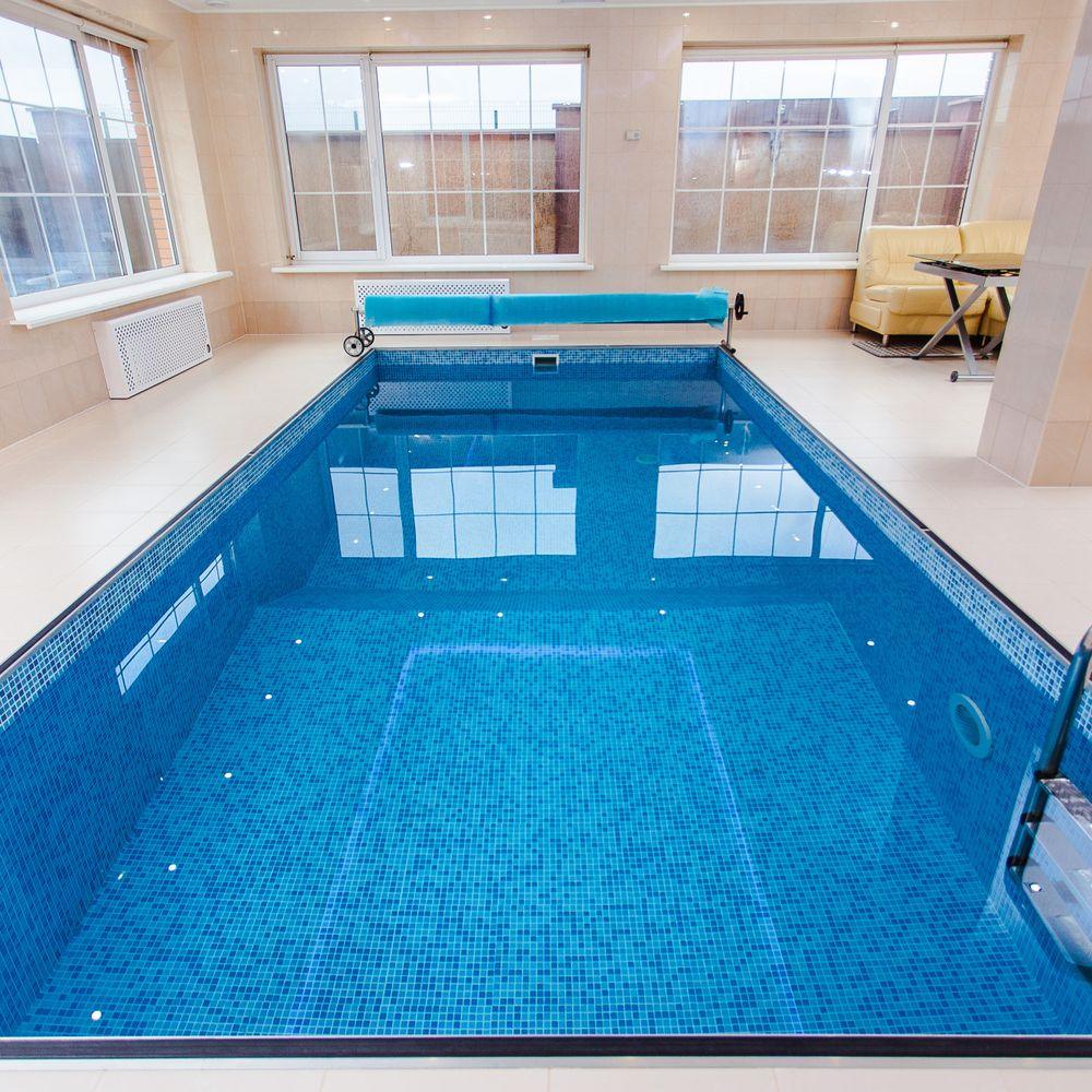 Bright indoor swimming pool, the kind of room a commercial pool dehumidifier keeps dry
