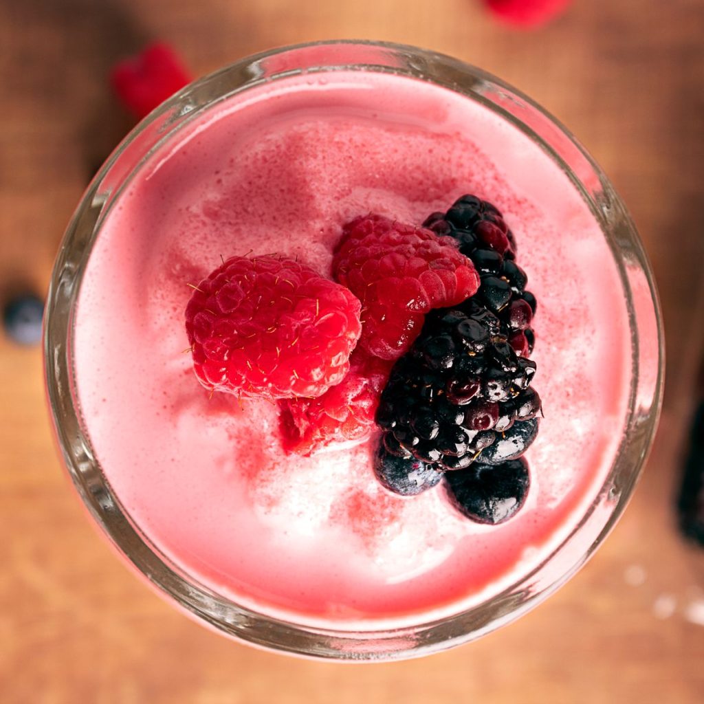 Mixed berry smoothie topped with raspberries and blackberries, blended in a Kuvings CB1000