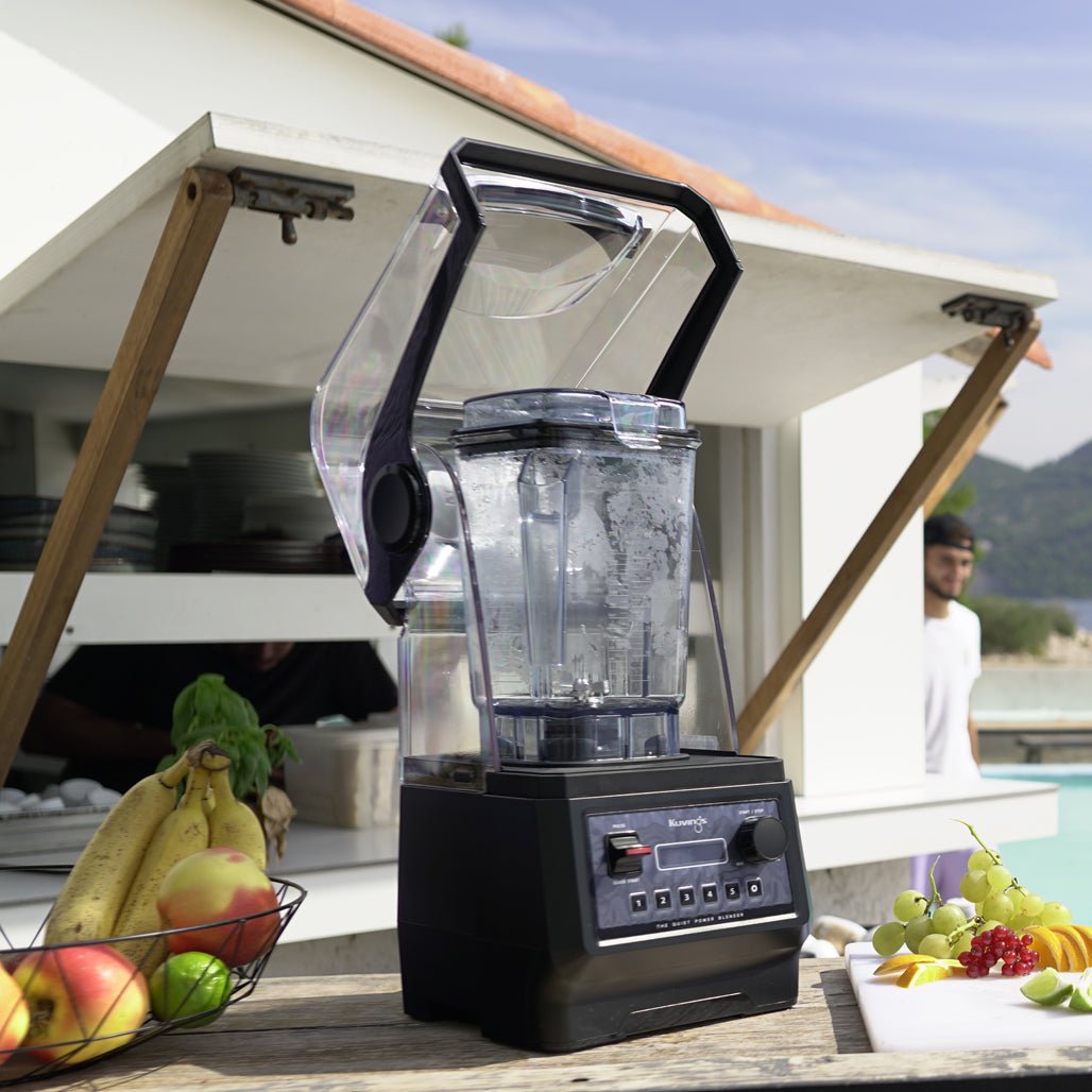 Kuvings CB850 with the hood open on a counter in an outdoor kitchen