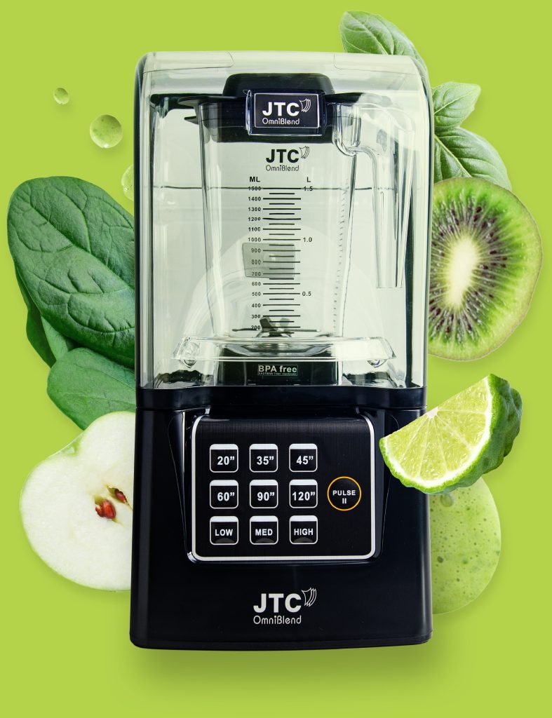 OmniBlend V+ commercial blender surrounded by spinach, kiwi, lime and apple