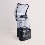 OmniBlend V+ commercial blender with the hinged sound cover open for access to the 1.5L jug