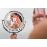 Photizo Blush used on the cheek, seen in a mirror
