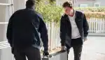 Installers fitting an EcoFlow OCEAN 2 battery outside a house