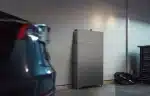 EcoFlow PowerOcean Single-Phase floor-standing system in a home garage beside a car
