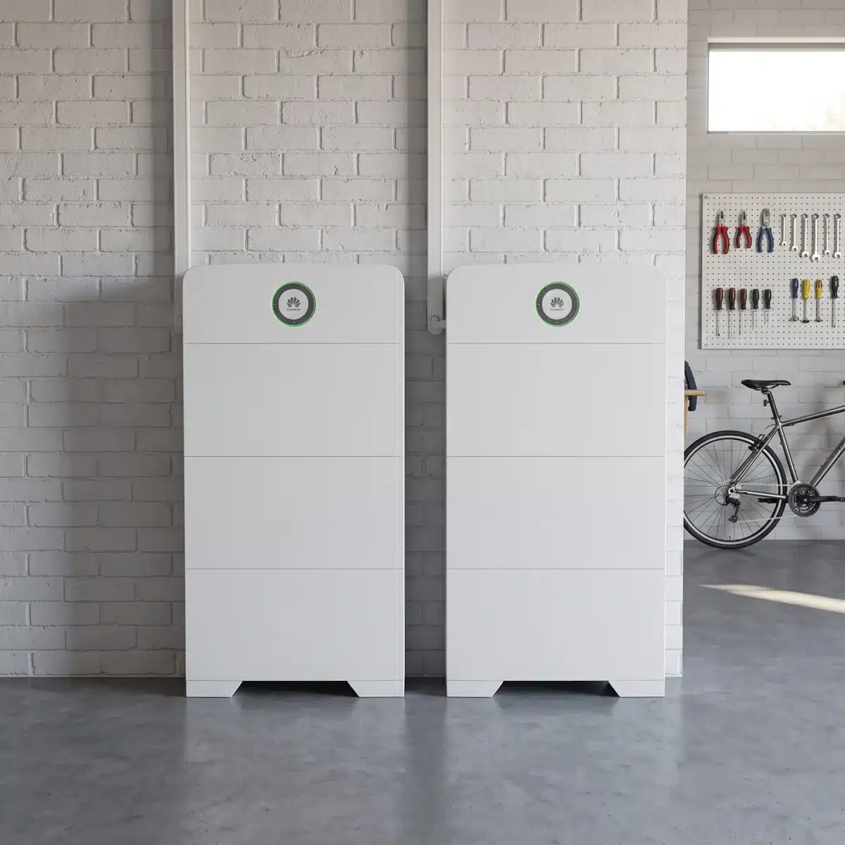 Huawei Power-M 10kW 30kWh system, two units against a white brick garage wall